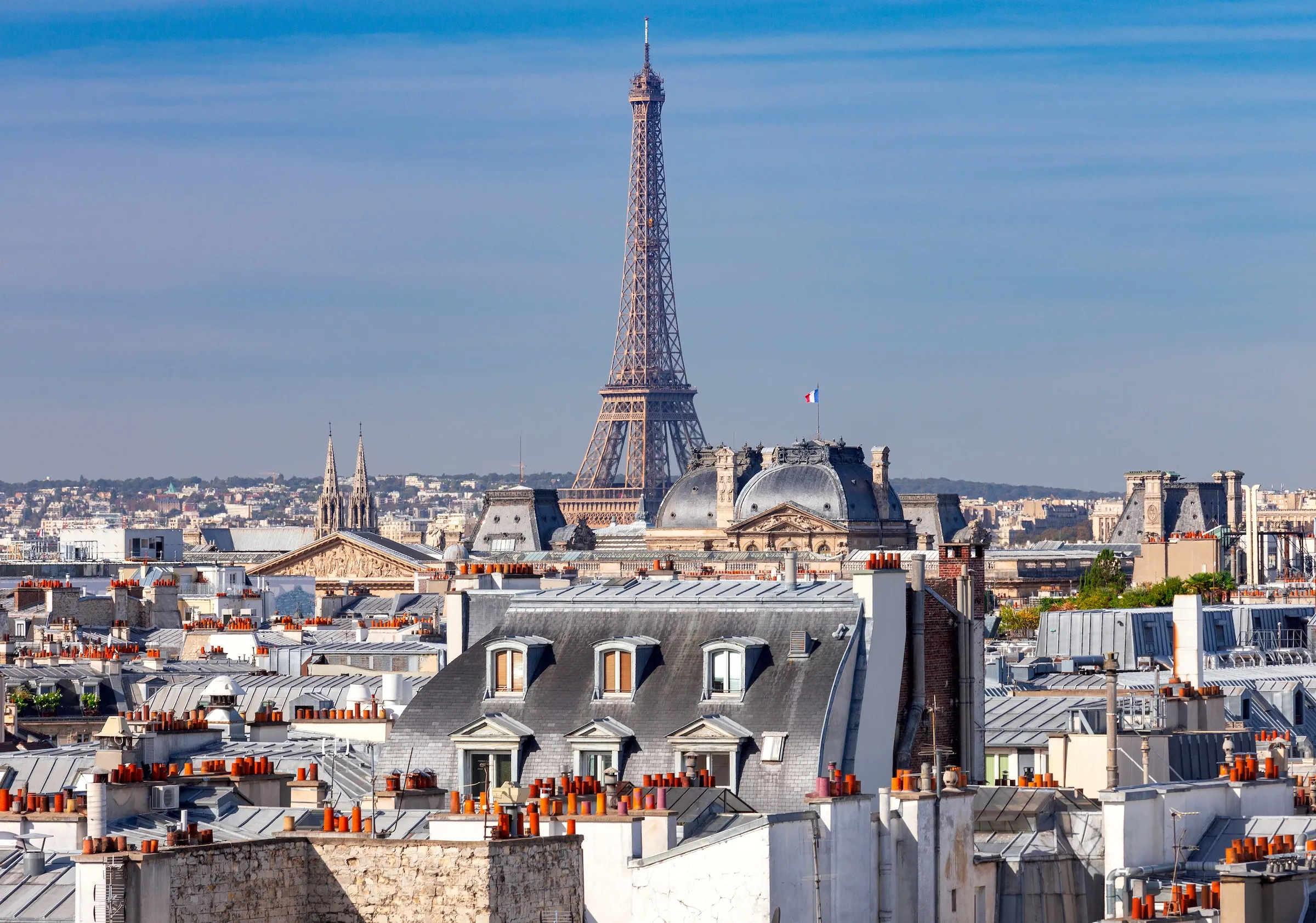 Aerial view of Paris rooftops with the Eiffel Tower in the background