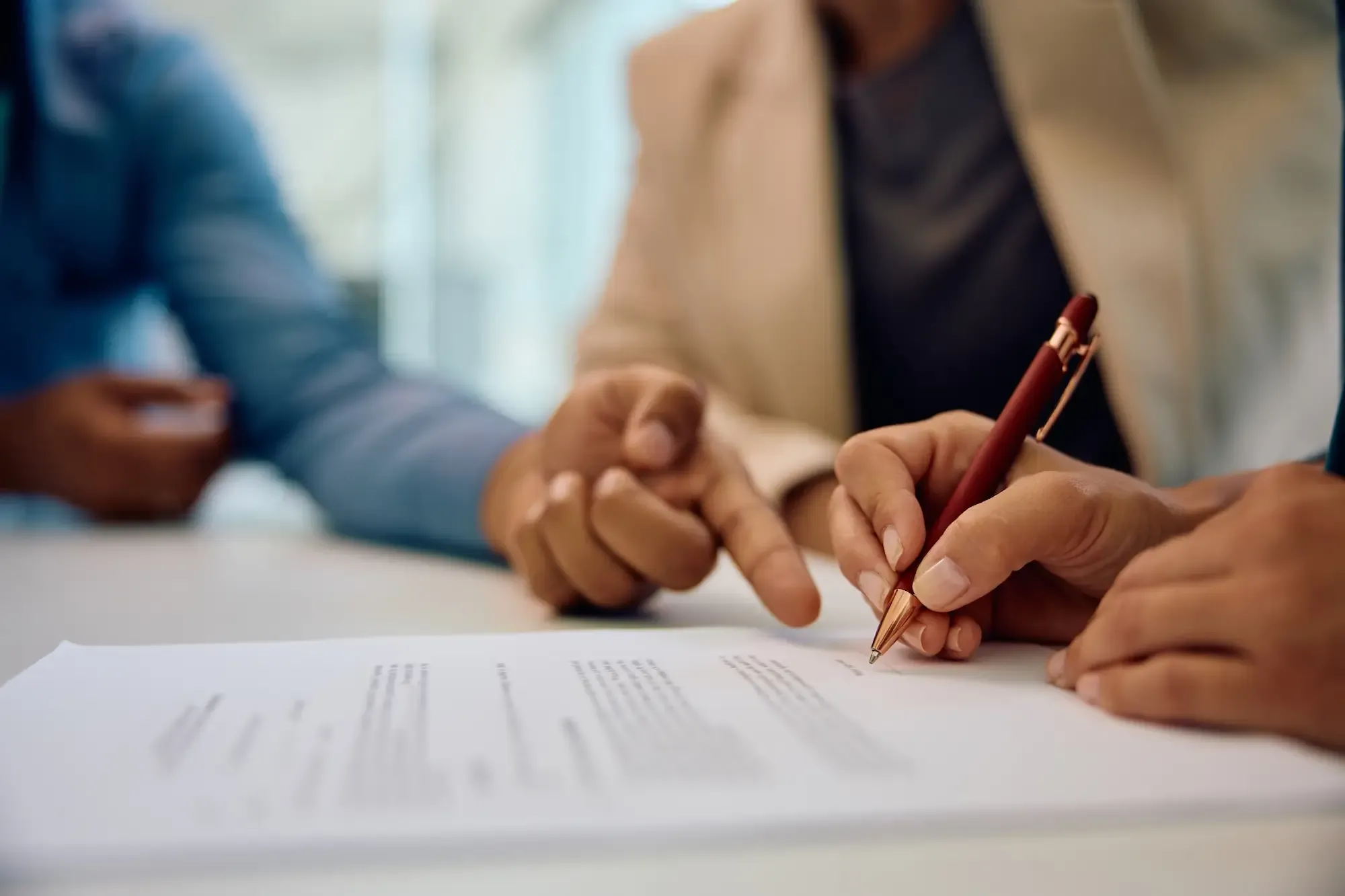 Couple signing the lease with a landlord in a Parisian apartment